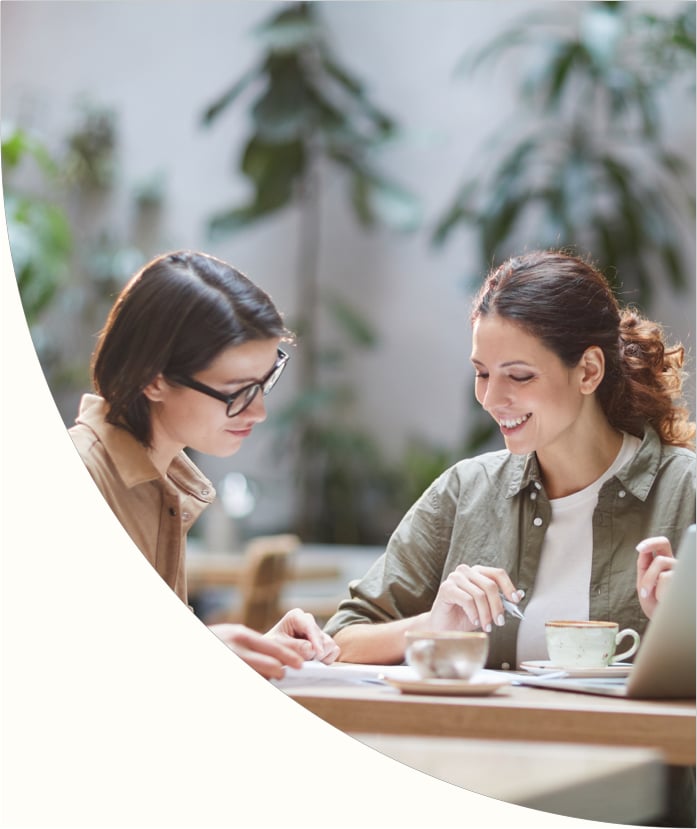 two women discussing financial health solutions over table