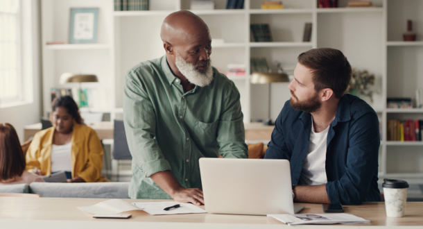 Tow businessmen working together on a laptop