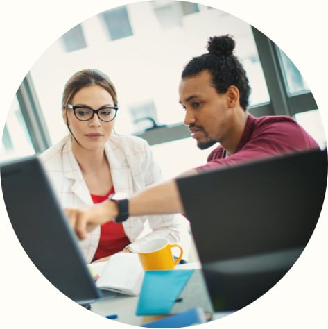 a businessman collaborating with his female colleage in the office 