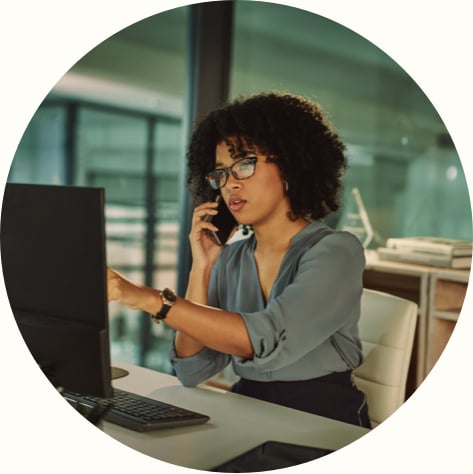 young businesswoman using a smartphone and computer in the office
