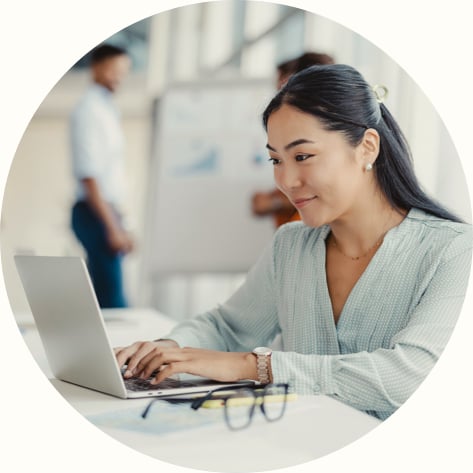 Asian woman working on laptop in office
